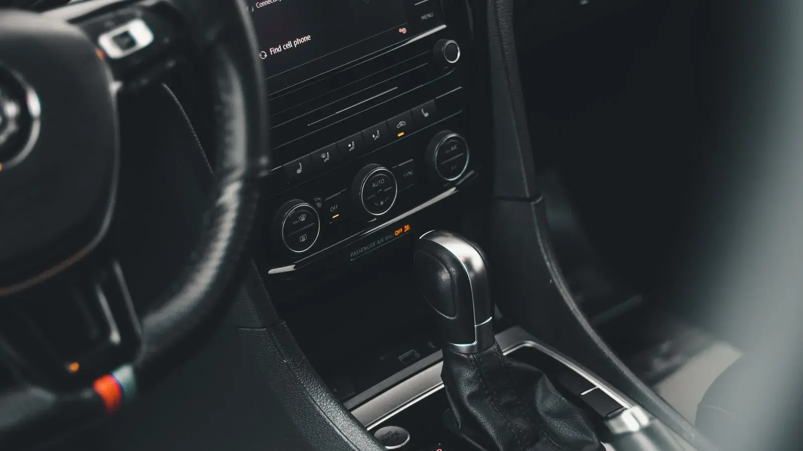 Photo by Dextar Studio ™ on Pexels Gear lever and center console inside a parked car.