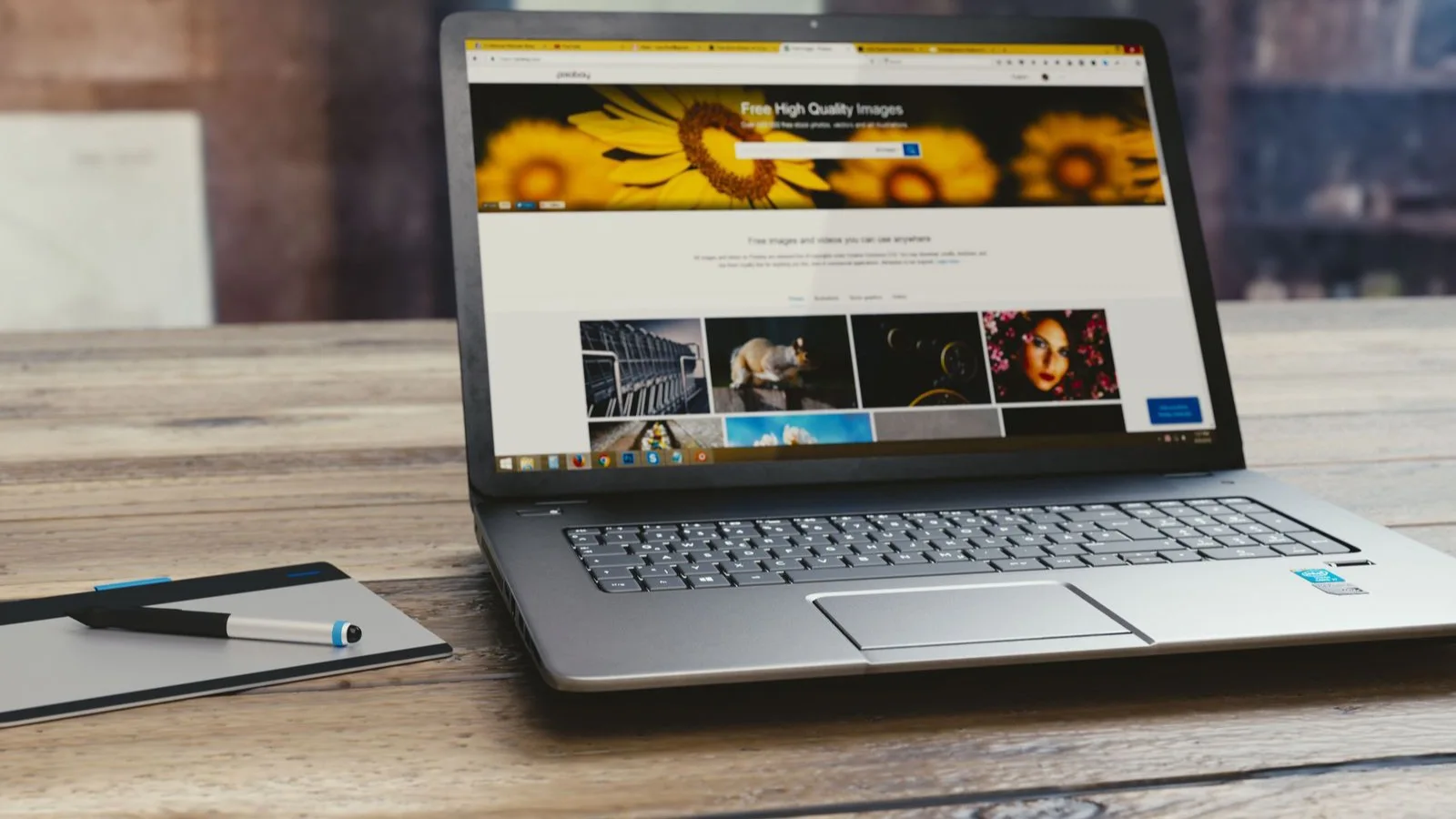 Photo by Monoar Rahman on Pexels A laptop showing a webpage on a wooden desk.